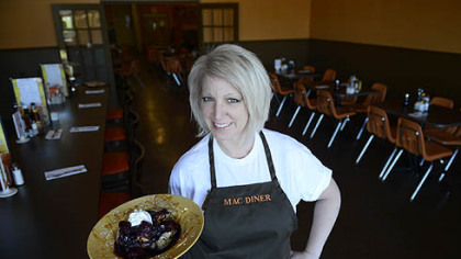Nancy Sukits, owner of MAC Diner in Hampton, holds creme brulée French toast with a berry compote. Her restaurant opened in Over the summer.