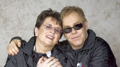 Billie Jean King and Sir Elton John embrace backstage before a WTT Smash Hits event.