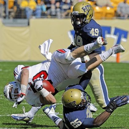 Louisville's Scott Radcliff is upended by Pitt's Jason Hendricks Saturday at Heinz Field. No. 18 Louisville spoiled Pitt's homecoming, riding a big second half to a 45-35 victory.