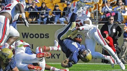Pitt's Rushel Shell flips into the end zone for a touchdown against Louisville in the second quarter Saturday at Heinz Field. The touchdown put the Panthers ahead, 21-14. Louisville then scored 31 of then next 45 points.