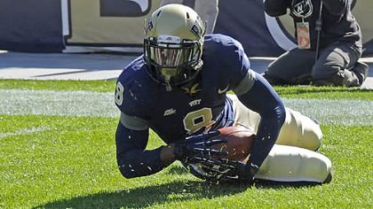 Pitt's Todd Thomas recovers a punt he blocked for a touchdown against Louisville in the second quarter Saturday at Heinz Field.
