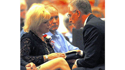 Pam Panchak/Post-Gazette
U.S. Rep. Tim Murphy presents a flag to Kim Raible on Saturday during a memorial for her son, Lt. Col. Chris Raible, who died in Afghanistan on Sept. 14.