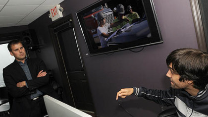 Rob Aho, left, a partner with BrabenderCox, talks with video editor Andy Kelemen in their Mount Washington office.