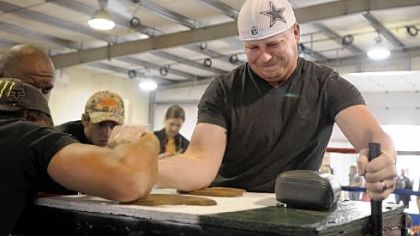 Rodney Offield of Texas tries to hold on but loses the arm wrestling championship match to Josh Frantz of Punxsutawney, Pa.