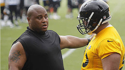 Veteran Casey Hampton, left, explains something to rookie Alameda Ta'amu during the team's minicamp.