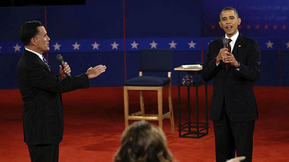 Republican presidential nominee Mitt Romney and and President Barack Obama answer a question during the second presidential debate at Hofstra University tonight.