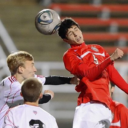 Peters Township's Nicco Mastrangelo heads ball past Moon's Brian Frenz Monday at Moon in the Indians' 3-0 win.