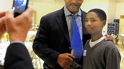 The Rev. Jesse Jackson poses for a photo Monday with 12-year-old DaiRon Burden at Mount Ararat Baptist Church.