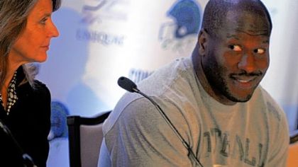 James Harrison, right, and Jennifer Branin, a mother and activist for youth athlete protection, discuss the Unequal Technologies Concussion Reduction Technology Tuesday.