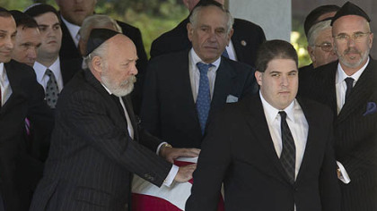 The flag-draped coffin of former U.S. Sen. Arlen Specter is taken from Har Zion Temple after his funeral today.