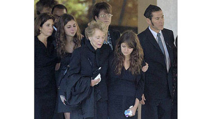 Joan Specter, third from left, and others leave Har Zion Temple Tuesday after her husband Arlen Specter's funeral.