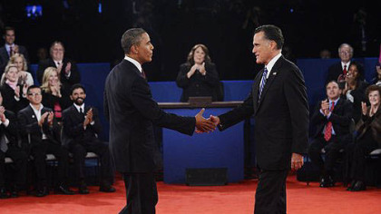 Moderator Candy Crowley, center, applauds as President Barack Obama shakes hands with Republican presidential nominee Mitt Romney during the second presidential debate at Hofstra University.