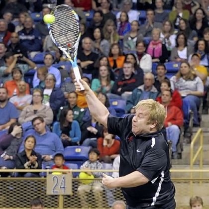 Elton John hits a shot at the Mylan World Team Tennis Match Smash Hits Tuesday at Petersen Events Center.