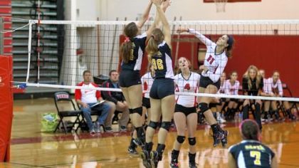 Fox Chapel's Sarah Bradley spikes a shot against North Allegheny as Alyson Hess watches.