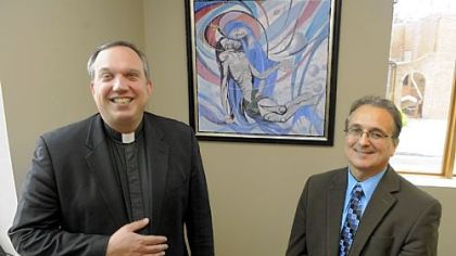 The Rev. David Peocking and Mark DeAndrea in front of the painting "Pieta" done by Mr. DeAndrea's father Frank at St. Elizabeth Ann Seton Church in Carnegie.