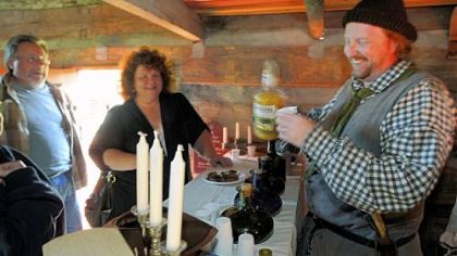 Bryan Cunning, right, serves drinks to Patrick and Lisa Guza of Gastonville, in the Bloody Dirt Tavern at the Enock Wright House in Peters.