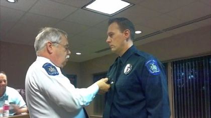 Collier police officer Daniel Elway, right, receiving an award from Chief Tom Devin.