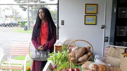 Autumn Redcross, a volunteer, stands by one of the last harvests from the Sewickley Food Pantry Garden on Wednesday in Sewickley.