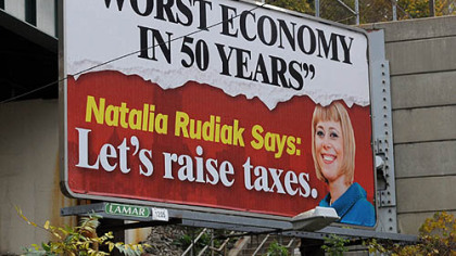 A Lamar billboard at the corner of Warrington and Boggs avenues, with the image of councilwoman Natalia Rudiak.