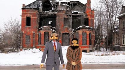 Performance artists is gas masks use decaying Detroit as a backdrop in a scene from the documentary "Detropia."