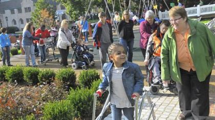Tamihya Goggin-Sapps, 8, walks in a parade on the new urban mobility trail Wednesday at the Western Pennsylvania School for Blind Children. In addition to the parade, races were held for the children on a portion of the trail. Before the trail was built, students had to be taken on actual streets to learn how to cross a road and listen for a traffic signal.