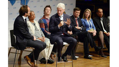 Bill Clinton answers questions while seated with David Jones, the co-founder of One Young World, during the opening ceremony for the One Young World Summit at Heinz Hall.