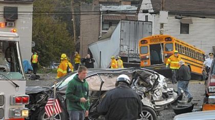 A trail of damaged vehicles is seen leading toward a tractor-trailer that lost control early Friday in the West End. Nine vehicles were involved. Three people were hospitalized.