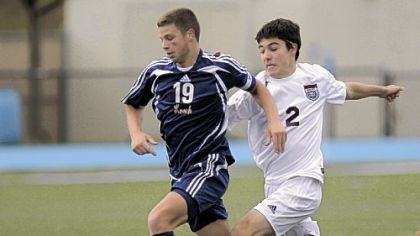 Knoch High School's Alex Slomer battles Beaver Area's Dillon McLaughlin for the ball in the preliminary round of the WPIAL Class AA boys soccer tournament at Seneca Valley High School.