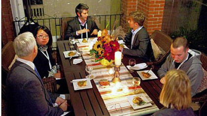 One Young World delegates gather for dinner at the home of Grant and Aradhna Oliphant (not shown) in Squirrel Hill on Saturday.