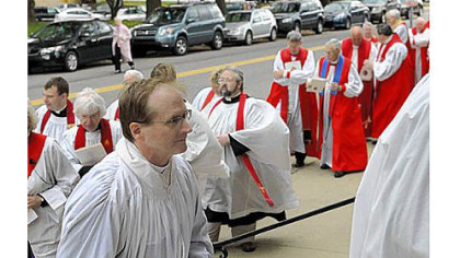 Bishop-elect Dorsey W.M. McConnell, front, processes up the steps to Calvary Episcopal Church in Shadyside for his ordination on Saturday.
