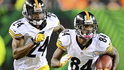 Antonio Brown picks up good yardage on punt return as Ike Taylor blocks for him against the Bengals Sunday at Paul Brown Stadium in Cincinnati.