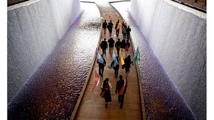 Delegates from the One Young World Conference walk underneath the David L. Lawrence Convention Center on Thursday.