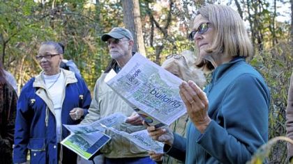 Monica Frolander-Ulf reads about the proposal for the new Frick Park Environmental Center during a nature walk Thursday hosted by the Pittsburgh Parks Conservancy.