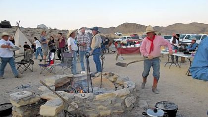 Stoking the fire at Cowboy Camp during the Original Terlingua International Championship Chili Cook-Off in Terlingua, Texas.