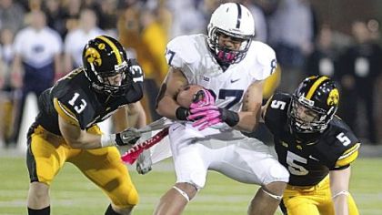 Kyle Carter makes a catch between Iowa's Tom Donatell, left, and Tanner Miller Saturday in Penn State's 38-14 win against the Hawkeyes in Iowa City, Iowa. Carter had six receptions for 85 yards.