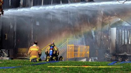 A rainbow appears while water is poured on the hotspots of the fire yesterday at a Creps United Publications facility near Indiana, Pa.