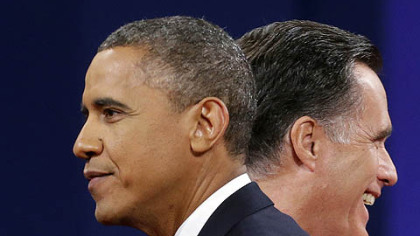 Republican presidential candidate, former Massachusetts Gov. Mitt Romney and President Barack Obama walk past each other on stage at the end of the last debate at Lynn University, in Boca Raton, Fla.