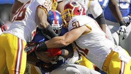 Washington's Ryan Kerrigan, right, and Josh Wilson stack up Giants running back Ahmad Bradshaw Sunday. Kerrigan is the next assignment for Steelers rookie Mike Adams.
Andrew Rush/Post-Gazette