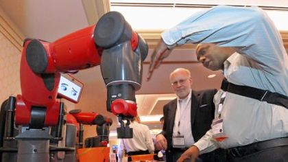 Baxter, an American-made robot manufactured by Rethink Robotics in Boston, is demonstrated to Anthony Jules, right, of Jules Studios by product manager Mike Bugda. The robot is fully equipped for about $25,000.