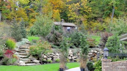 A rustic stone wall divides the back of the Romboski garden into two levels.