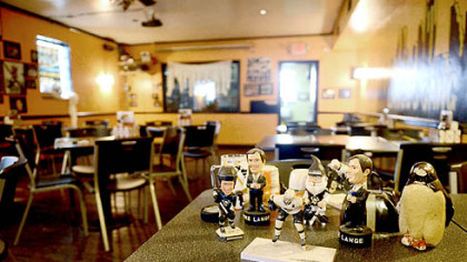 At Excuses Bar and Grill on the South Side a collection of tchotchkes lines a table Tuesday. Excuses, a regular destination for Penguins fans, has seen attendance drop drastically because of the NHL lockout. The lucky trinkets include a bottle of Tang signed by Kris Letang, a hockey puck that for good luck must be kept in a freezer between games and a ceramic penguin named Clinchy who must be facing the screen during games.