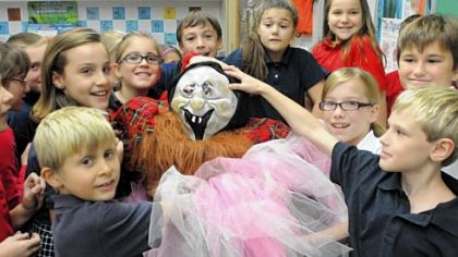 Fourth-graders from Kelly Ryan's class at St. Sebastian School in Ross assemble scarecrows at the school last week.