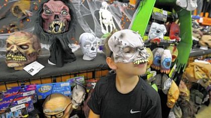 A face in the crowd, Gage Clark, 10, models a mask he picked out at Dreams to Screams Halloween Super Store, North Versailles.