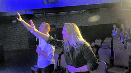 Exalt Church pastor Thomas Ondrea and wife Christine pray during a musical hymn on Sunday at Wilson Christian Academy.