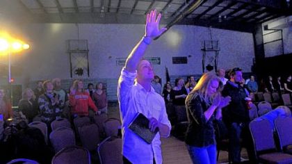 Services at Exalt Church, which set up Sunday at Wilson Christian Academy in West Mifflin, includes prayer with plenty of musical and graphic elements. Says worshiper Ken Logsdon: "We've bought into their vision of doing church a bit differently but still sticking to a serious message."