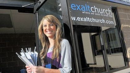 Angellia Logsdon welcomes people to Exalt Church at Wilson Christian Academy on Sunday.