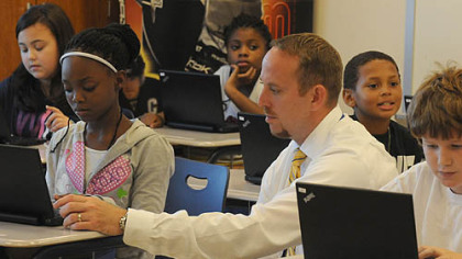 Jason Patrai, sixth grade science and math teacher, works with students at West Mifflin Middle School.