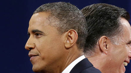 Republican presidential candidate, former Massachusetts Gov. Mitt Romney and President Barack Obama walk past each other on stage at the end of the last debate at Lynn University, in Boca Raton, Fla.