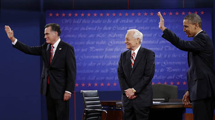 Moderator Bob Schieffer, center, watches as Republican presidential nominee Mitt Romney, left and President Barack Obama  wave to members of the audience during the third presidential debate at Lynn University, Monday, Oct. 22, 2012, in Boca Raton, Fla.