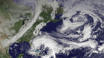 In this image taken by NOAA today, Hurricane Sandy is seen in the center bottom.